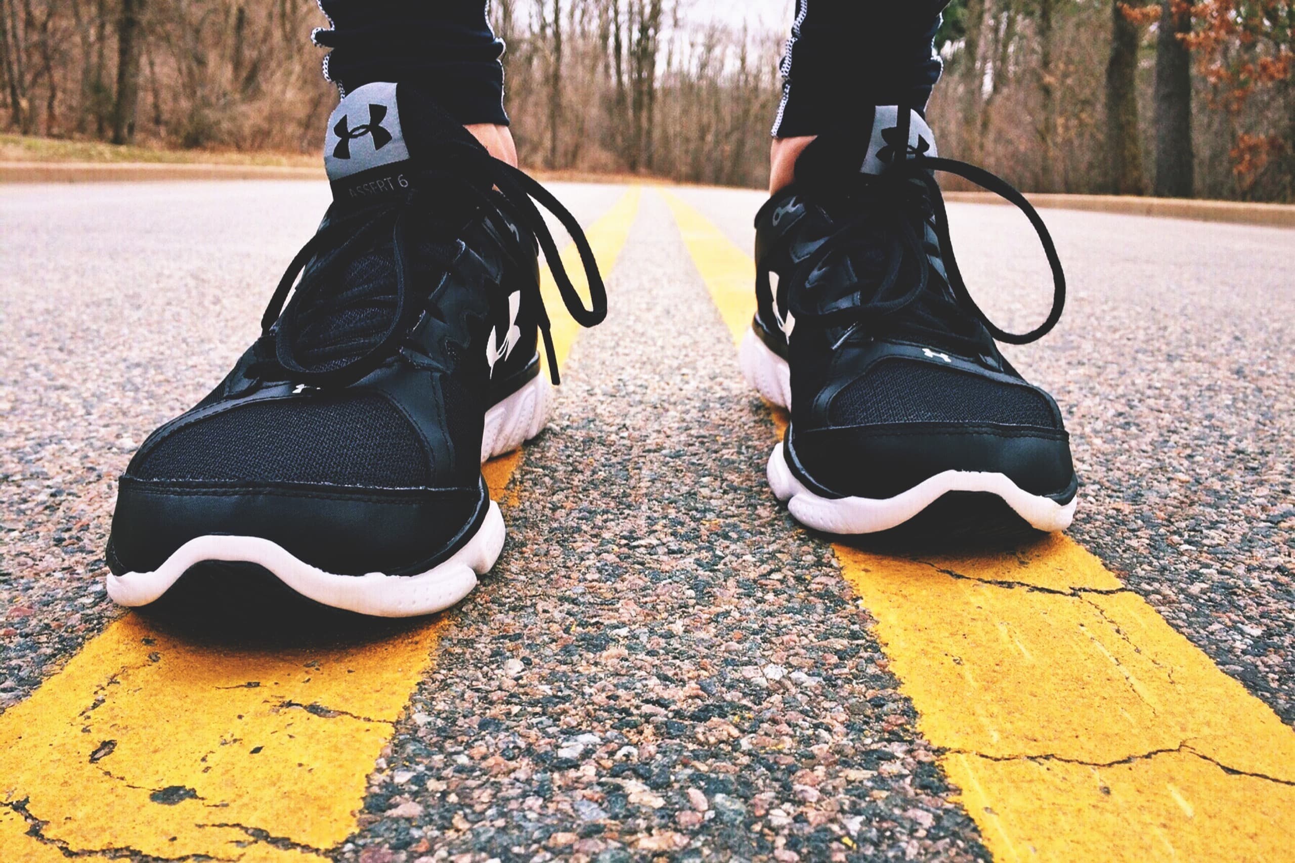 Running shoes striding along a road